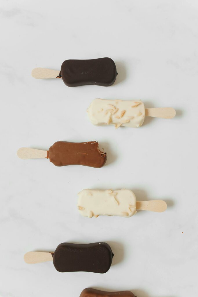 Delicious assortment of chocolate and vanilla ice cream bars on sticks.